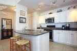 Kitchen has ample kitchenware, high-end appliances and breakfast bar. 